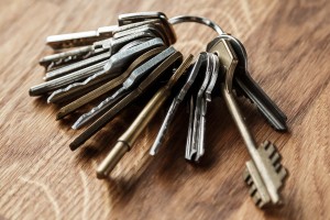 Bunch of different keys on wooden table